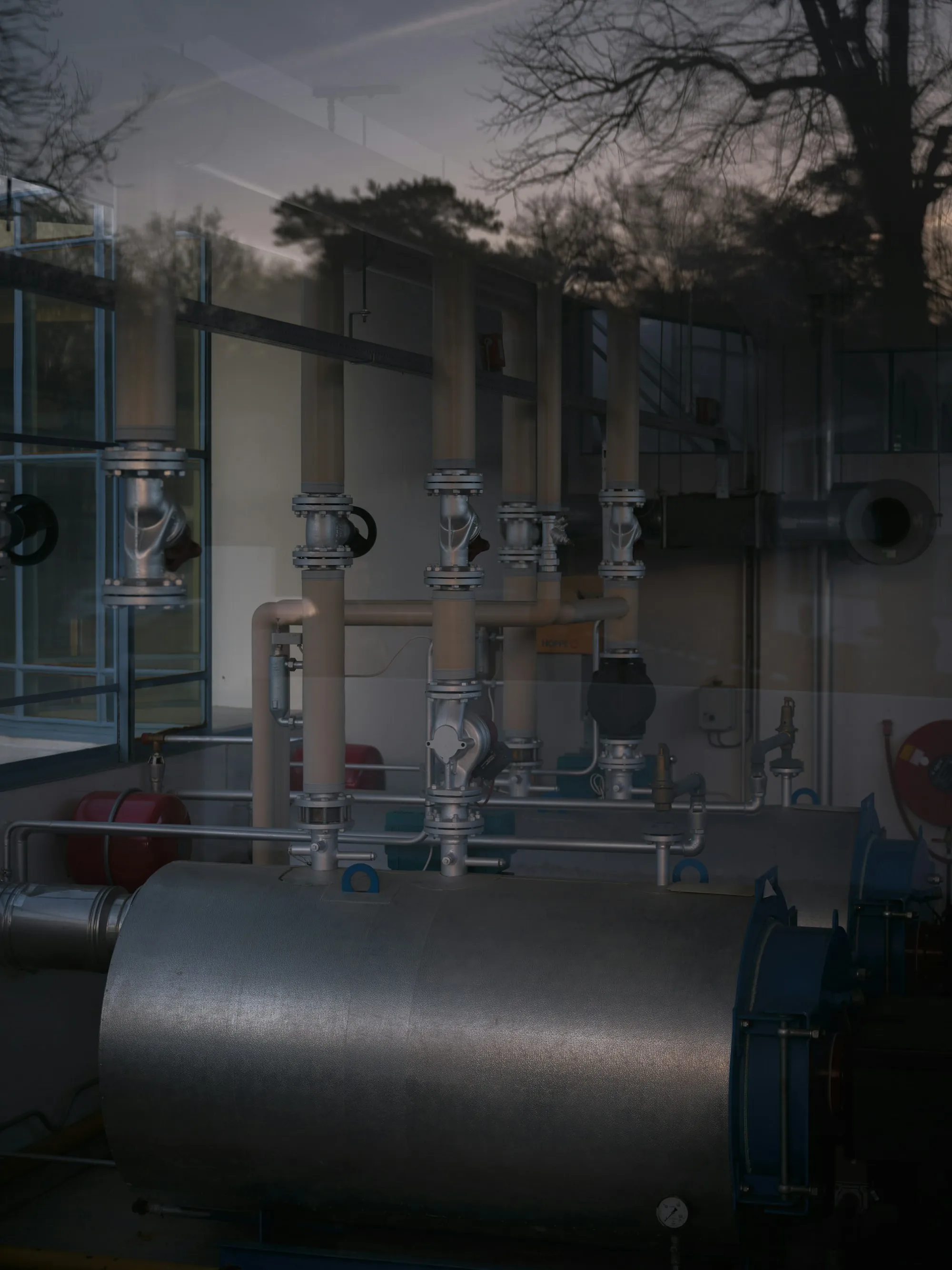 Utility room with pipes, valves and a heating system